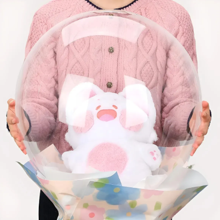 Globo burbuja transparente con peluche rosa y confeti